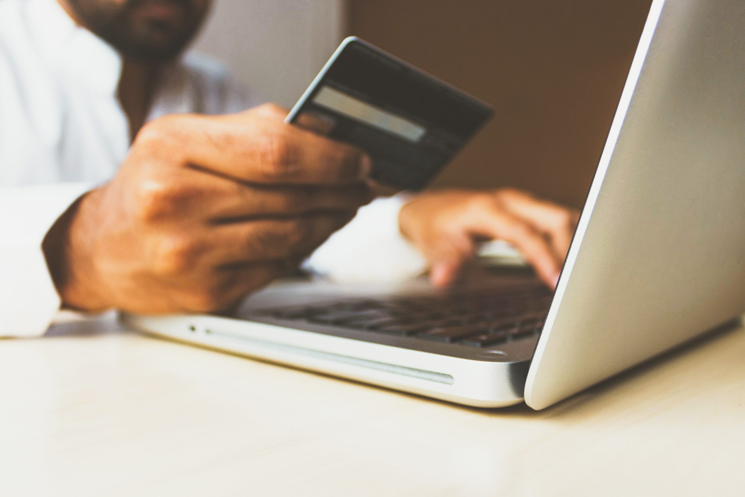 Man entering credit card number to place an online order