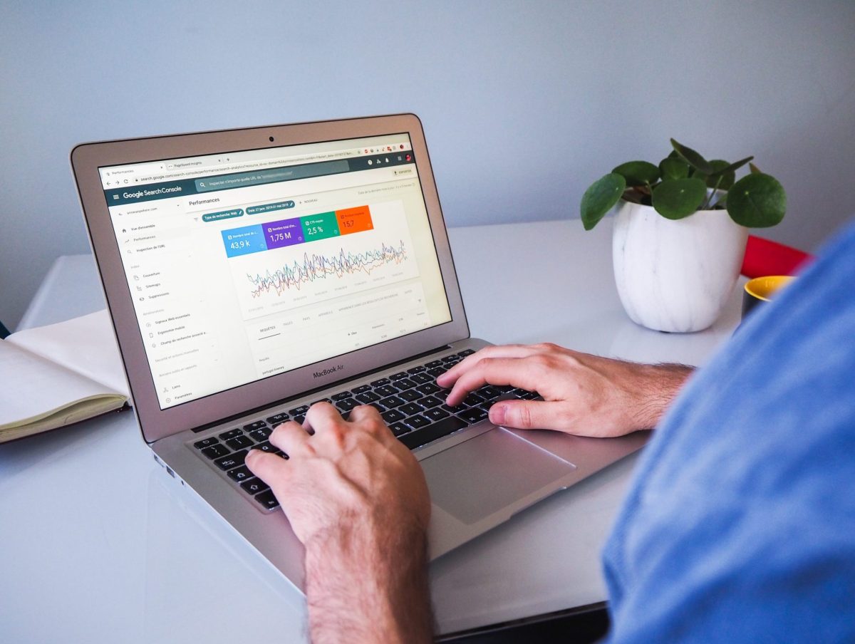 A laptop screen showing the Google Search Console dashboard with key metrics and information on Search Engine Optimization (SEO) performance.