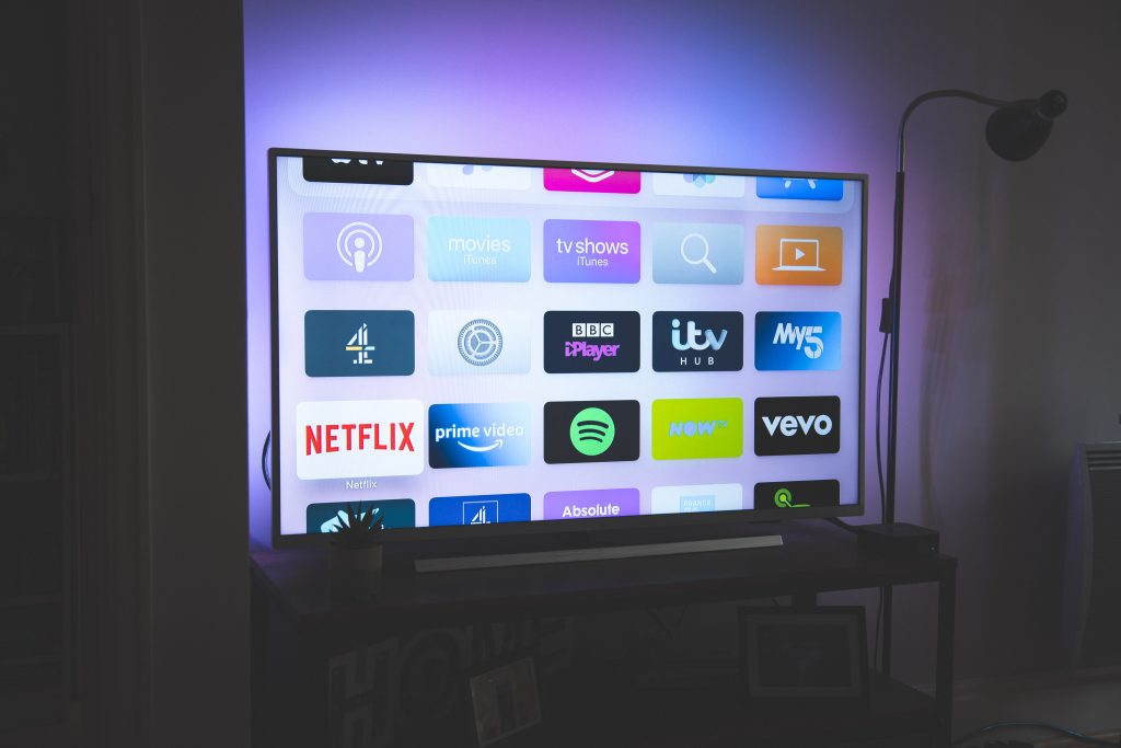 A TV displaying the Apple TV home screen. 