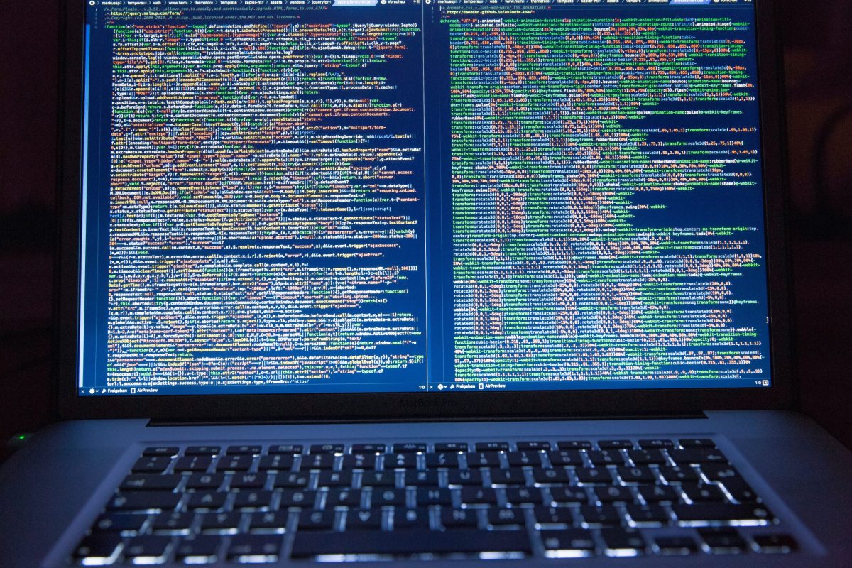 A laptop screen displaying backend code for a website that has been optimized for SEO