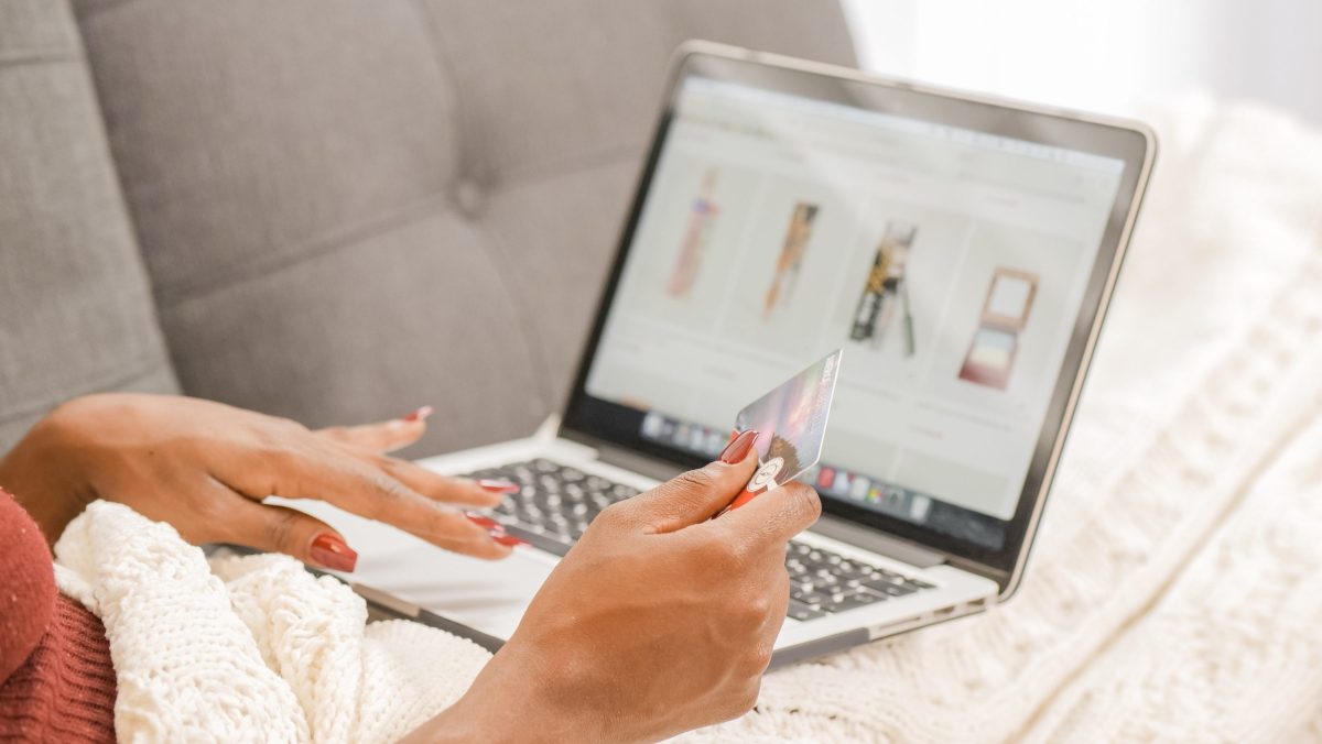 A woman holding a credit card while online shopping