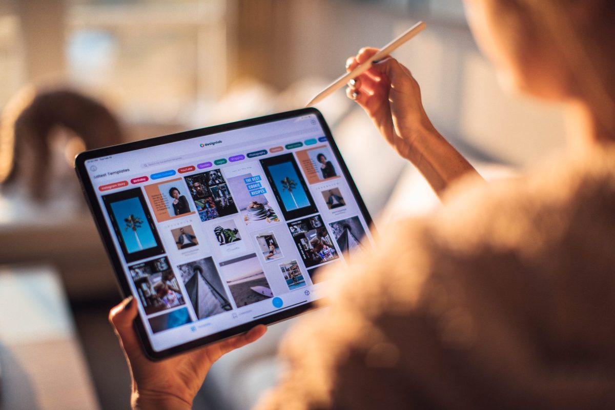 A person scrolling through different images on a tablet