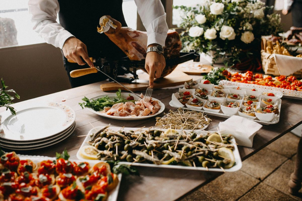 A chef preparing several dishes of food